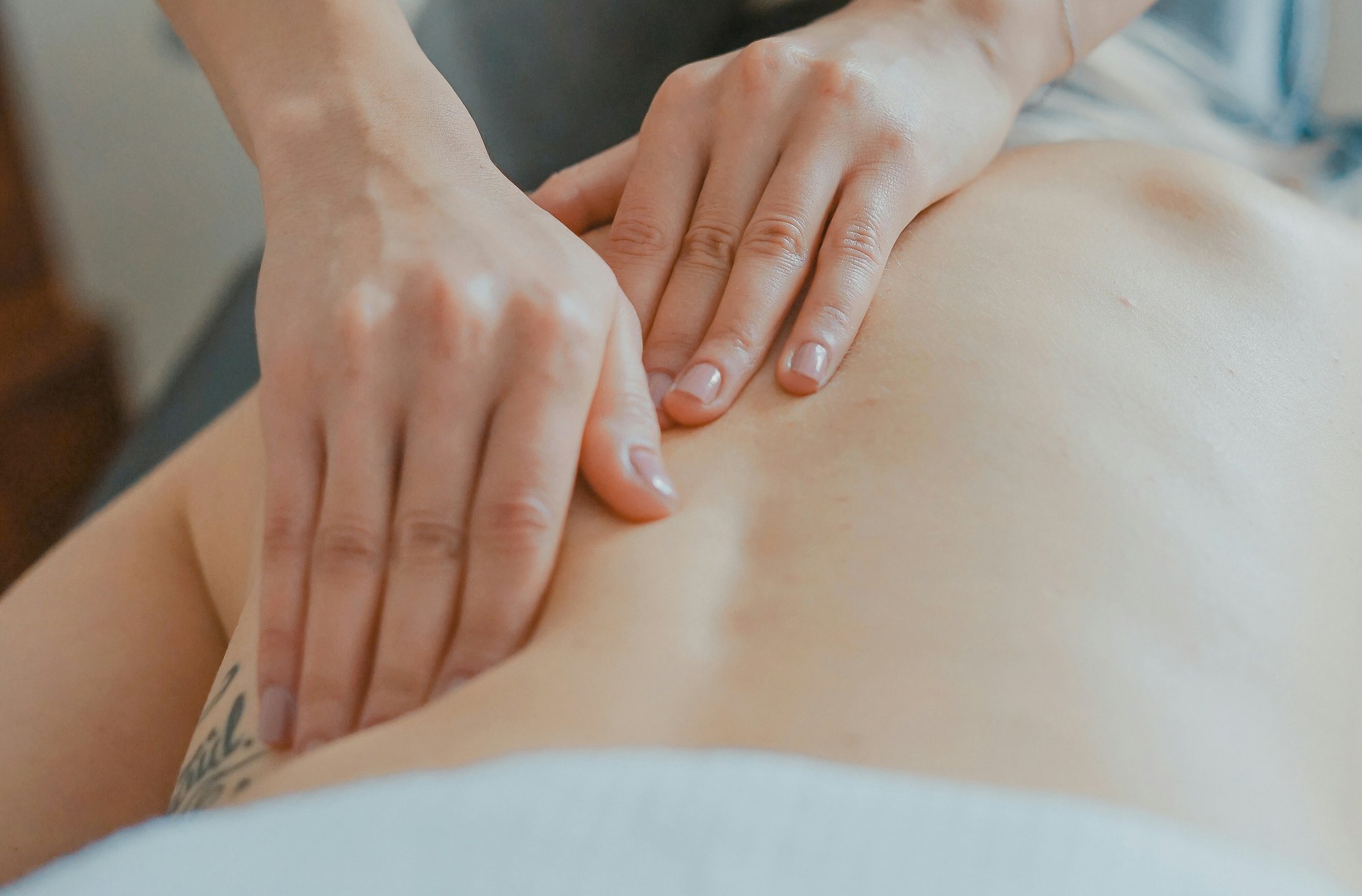 Physical therapist performing soft tissue mobilization on a patient's leg